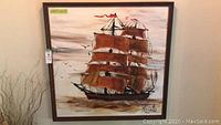 Full view of framed ship painting with brown sails and birds, showing size label 42.5 x 42.5 and signed Reynolds.