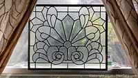 Front view of the leaded glass panel showing entire symmetrical floral geometric design with textured and beveled clear glass pieces.