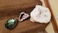 Geodes and seashell on carpeted stairs showing overall size and appearance