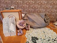 Full view of the mat, drapery panels wrapped, framed K. Cantin prints, punched white metal desk set, and poseable bear.