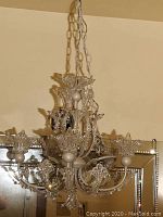 Front view of chandelier hanging from chain