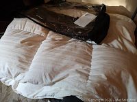 Queen size white duvet neatly folded showing its quilted structure