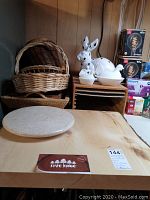 Full lot showing live edge wood board with natural bark, marble lazy Susan, white ceramic bunny on stacked boards, and multiple wicker baskets.