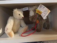 Image showing Steiff articulated bear and Stompy pony plush side by side on a shelf.
