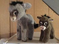 Front and side views of the two donkey plush toys, showing size comparison and fiber texture.