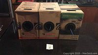 Three boxes of Cat 5e cable with front labels showing brand and specs
