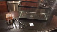 Full view of Hagen glass fish tank and accessories on black countertop