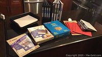 Overview showing new black 3-ring binders, unopened Avery label packs, manila and red file folders, and envelopes