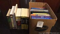 Photo of boxed and stacked textbooks including programming and business-related titles