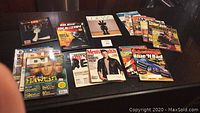 Photo showing a collection of twelve magazines on a dark surface including Life 1997 with Princess Diana on the cover, Men's Health, Blue 'N Bad, and various other titles related to entertainment and cars.