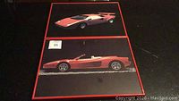 Front view of two framed custom car prints showing a Lamborghini Countach and a Ferrari Testarossa convertible with red frames on black background.