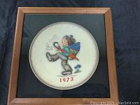 Framed 1973 Hummel plate showing full plate and frame including marks on background.