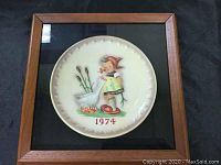 Full view of framed vintage 1974 Hummel plate, showing wood frame and plate design.