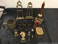 Full lot of brass and copper items on black cloth background, showing all pieces described in the seller text.