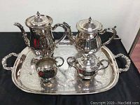 Full view of the silver plated tea set on tray showing teapot, coffee pot, creamer, and sugar bowl
