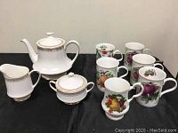 Royal Albert Linford pattern teapot, creamer, sugar bowl, plus six assorted fruit pattern mugs.