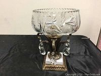 Front view of the complete crystal centerpiece bowl on metal and marble base with hanging crystal prisms.