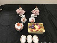 Full lot overview showing all porcelain items including figurines, jewellery boxes, shakers and open salts.