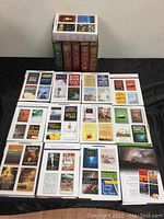 Photo of 20 hardcover Reader's Digest Condensed Books arranged flat on black surface, showing front covers with various book titles and authors.