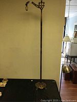 Full view of the entire antique bridge floor lamp standing approximately 58 inches tall, showing the base and curved arm.