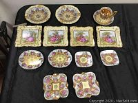Overview of collection including 4 small dishes, 4 ashtrays, demitasse cup with saucer, and 4 wall plaques showing decoration and condition