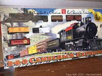 Full front view of the train set box showing the locomotive and multiple cars in packaging.