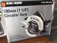 Box of Black & Decker 180mm (7 1/4") Circular Saw with product details and 2-year warranty visible.