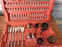 Close-up view of the sanding drums, hole saws and a large drill bit