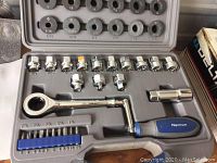 Top view of offset sockets, ratchet, screwdriver handle, and bits inside molded plastic case