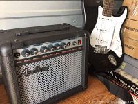 Academy GF-15 amplifier front showing control knobs, speaker grille, and branding