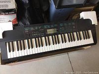 Full view of the keyboard showing all 61 keys and side panels with speakers.