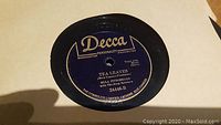 Close-up photo of a 78 RPM vinyl record labeled 'Tea Leaves' by Ella Fitzgerald and the Tommy Dorsey Orchestra on the Decca label.