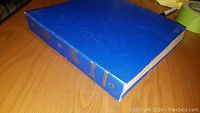 Blue binder used to hold 12 vintage 78 RPM vinyl records, showing binder spine and cover.