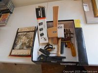 Overview photo of all lot contents in a box showing saw blades, hand tools, honing guide, hammer, mini clamp, Waterstone holder box