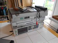 Three stacked units: record player case on top, Sylvania combo unit in middle, Sony receiver on bottom