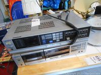 Top view of silver Sony stereo receiver and cassette player stacked together showing model number label and general design.