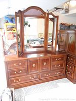 Front and side view of Strathroy 6-drawer dresser with attached trifold mirror showing the drawer configuration and wood finish