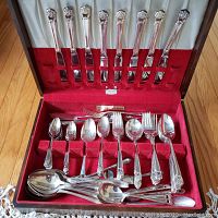Full open canteen shot displaying all cutlery pieces arranged in red velvet lined slots.