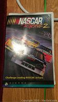 NASCAR Racing 2 User Guide booklet cover showing three race cars and Sierra logo.