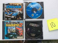 Four PC driving games displayed with discs and cases as available. Driver and Midtown Madness 2 have cases with covers, two others shown discs only.
