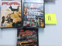 Three PC video game cases: Pure, Grand Theft Auto IV, and Dirt Track Racing