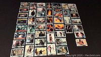 Photo showing all 47 cards from the vintage Star Wars Empire Strikes Back Series 2 Blue Set spread out in rows on a dark surface.