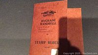 Brown cover of the stamp block book with 'Hygrade Handifille for Stamp Blocks' text and handwritten markings