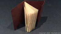 Brown album/book of approximately 20 pages containing mounted stamps