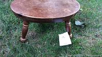 Top and side view of an antique oval wooden stool with visible wear and patina.