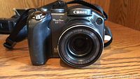 Front view of Canon Power Shot S3 IS camera showing lens and body.