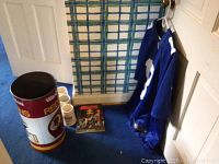 Full view of the Redskins wastebasket, four mugs, vintage magazine, and NY Giants Beckham Jr. jersey hung on door