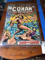 Front view of Conan the Barbarian #1 comic book in plastic bag on wooden table