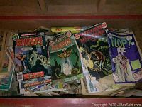 Close-up of top layer comics including DC Ghosts, Weird Mystery, Plop!