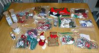 Overview of all Christmas decorations including ornaments in plastic bags, tubes with stars and icicles, and various fabric ornaments.